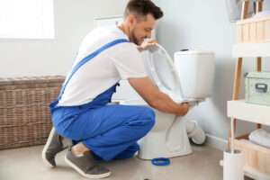 plumber fixing a toilet valve